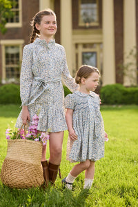Little English traditional children's clothing. Capped sleeve blue, brown, and cream floral smocked dress with peter pan collar for little girls.