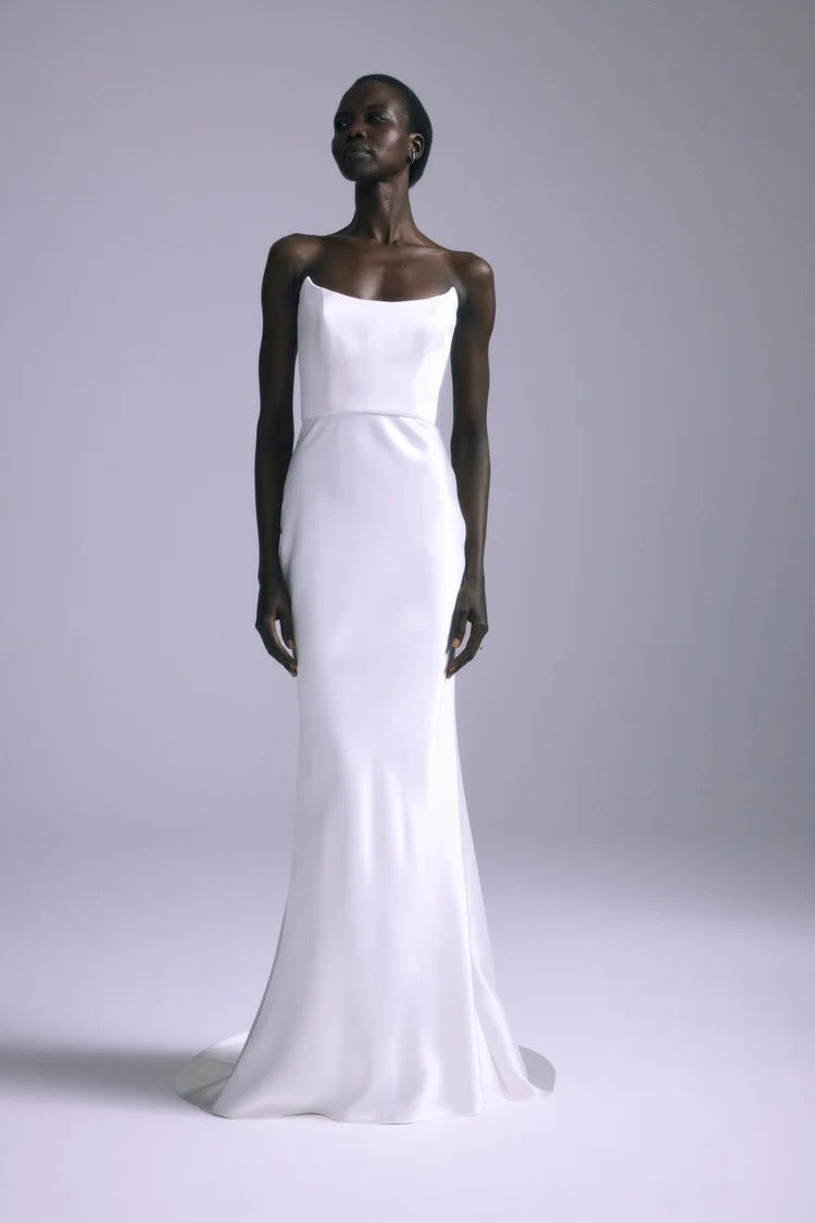 Front view of Haiku Gown white satin bias slip gown showing pointed bodice and slim floor-length silhouette on model against gray background