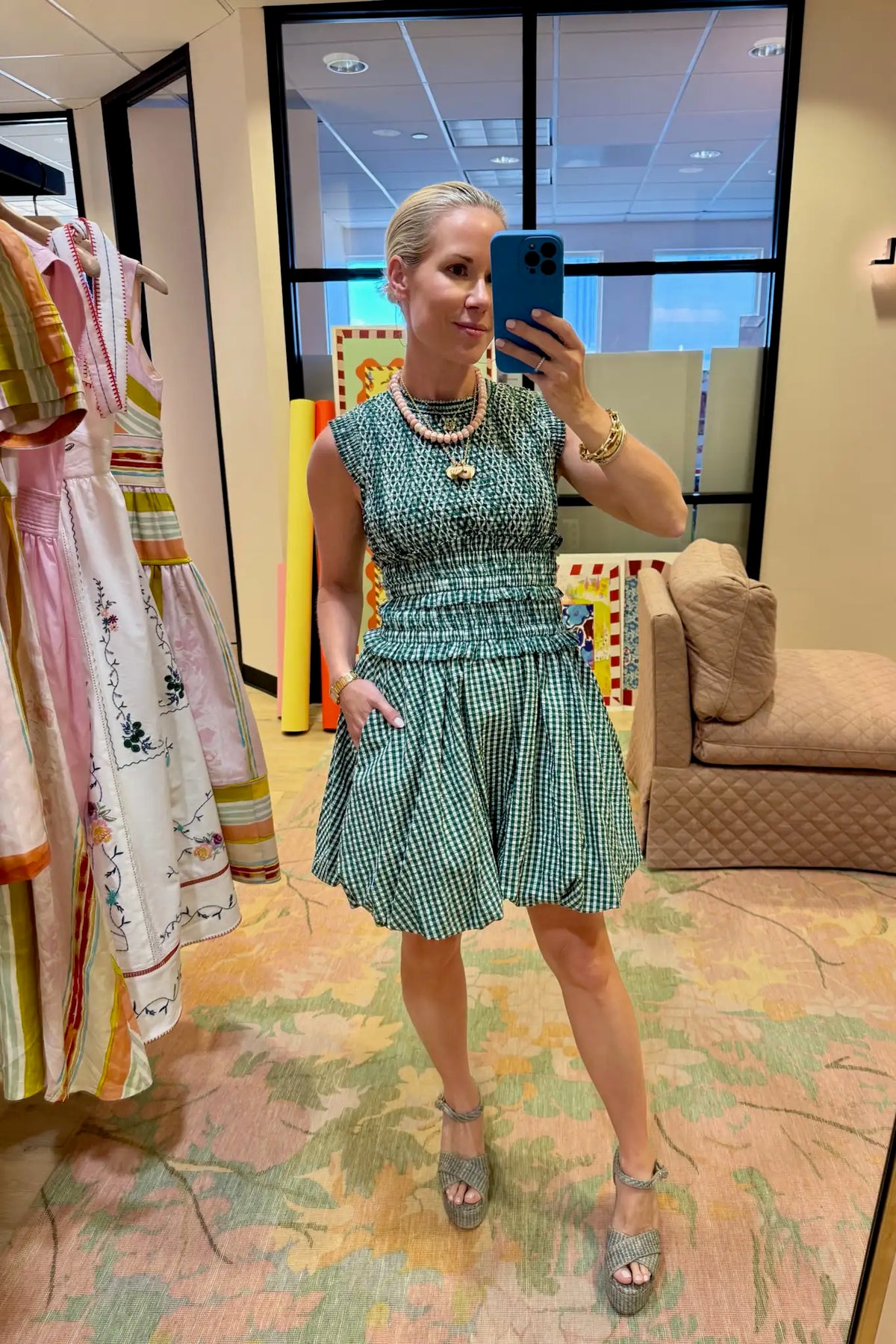 The Anita Dress has a diamond-smocked bodice, flutter cap sleeves, a back tie and a bubble skirt.