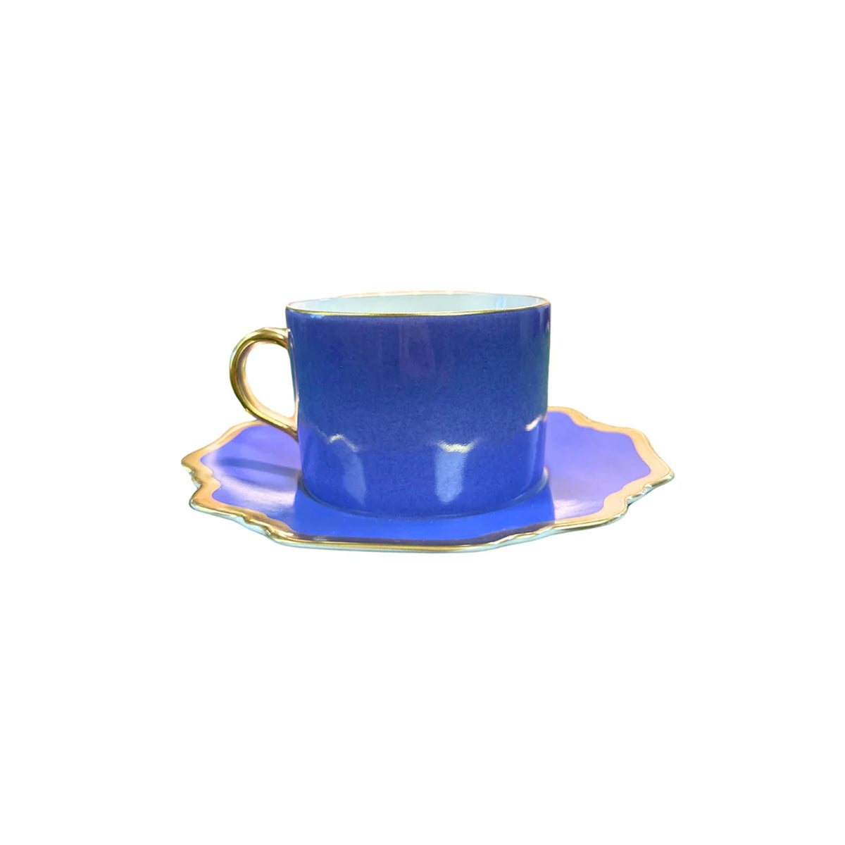 Front view of Anna’s Palette Tea Cup in Indigo Blue showcasing its bold blue porcelain body with a golden rim and handle on a white background