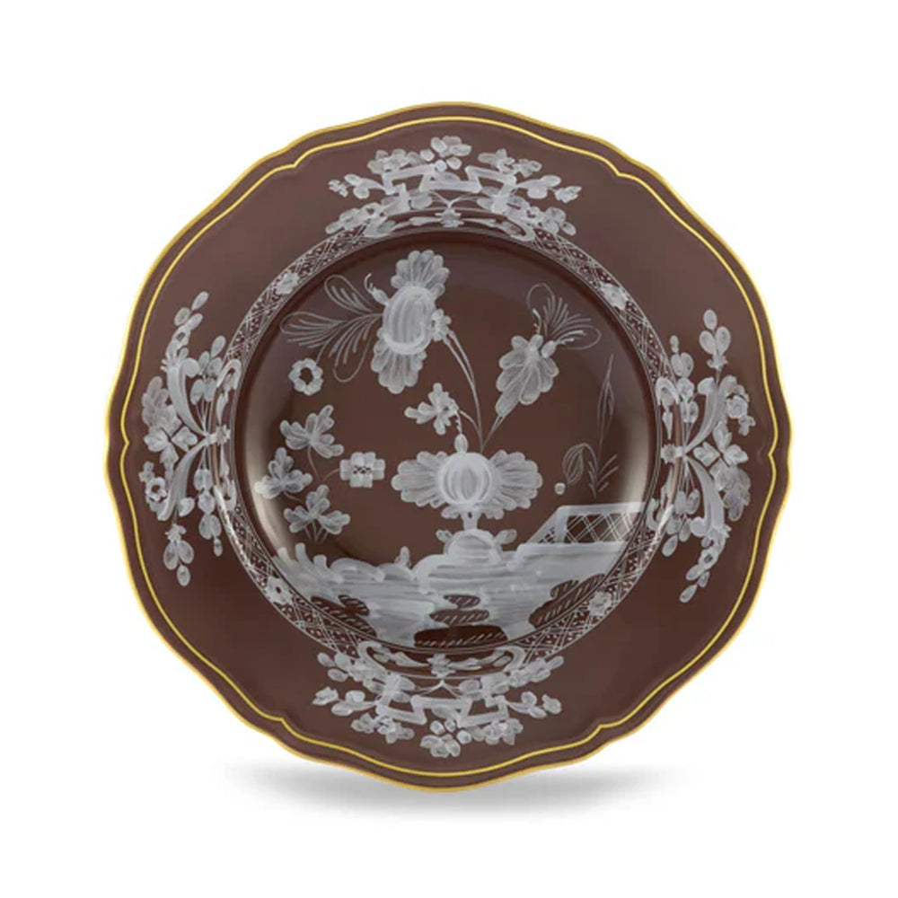 Top view of Oriente Italiano Antico Doccia soup plate in Castagna with floral motifs and scalloped gold rim on white