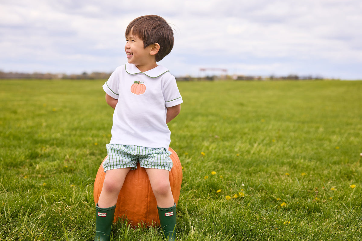Little English classic short set for little boys.  White knit peter pan shirt with applique pumpkin at the center and coordinating banded shorts in green Leland Plaid.  
