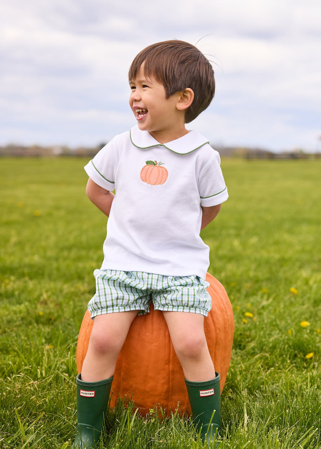 Little English classic short set for little boys.  White knit peter pan shirt with applique pumpkin at the center and coordinating banded shorts in green Leland Plaid.  