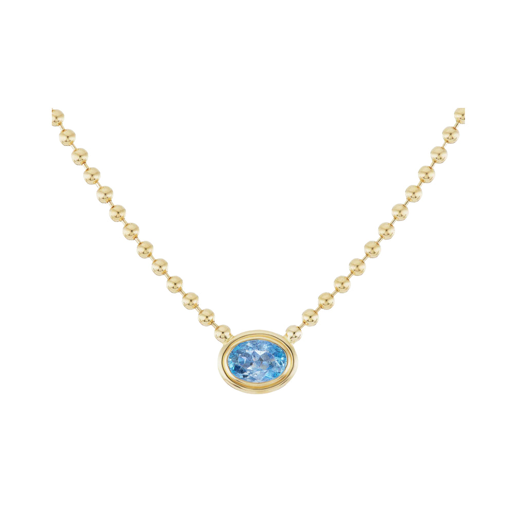 Front of Aquamarine Double Bubble Bezel Necklace showing oval aquamarine in 18K yellow gold with beaded chain on white