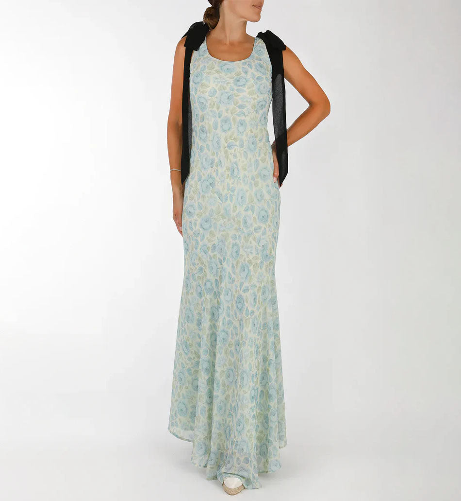 Front view of Sydney Dress in Something Blue showing fitted bodice, flared maxi skirt, floral print and fixed black shoulder bows
