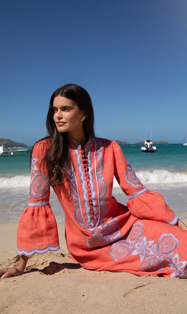 Front view of the Cerise Bleu Celine Kaftan showcasing blue embroidery, appliqué, and bell sleeves on a beach