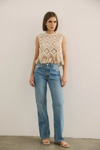 The Astor Top in cream paired with denim jeans.