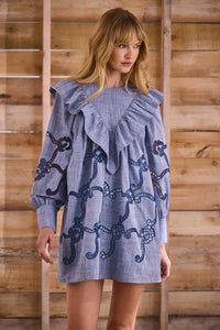 Blue cut-out embroidered linen, crew neckline, softly ruffled yoke, long sleeves with button cuffs