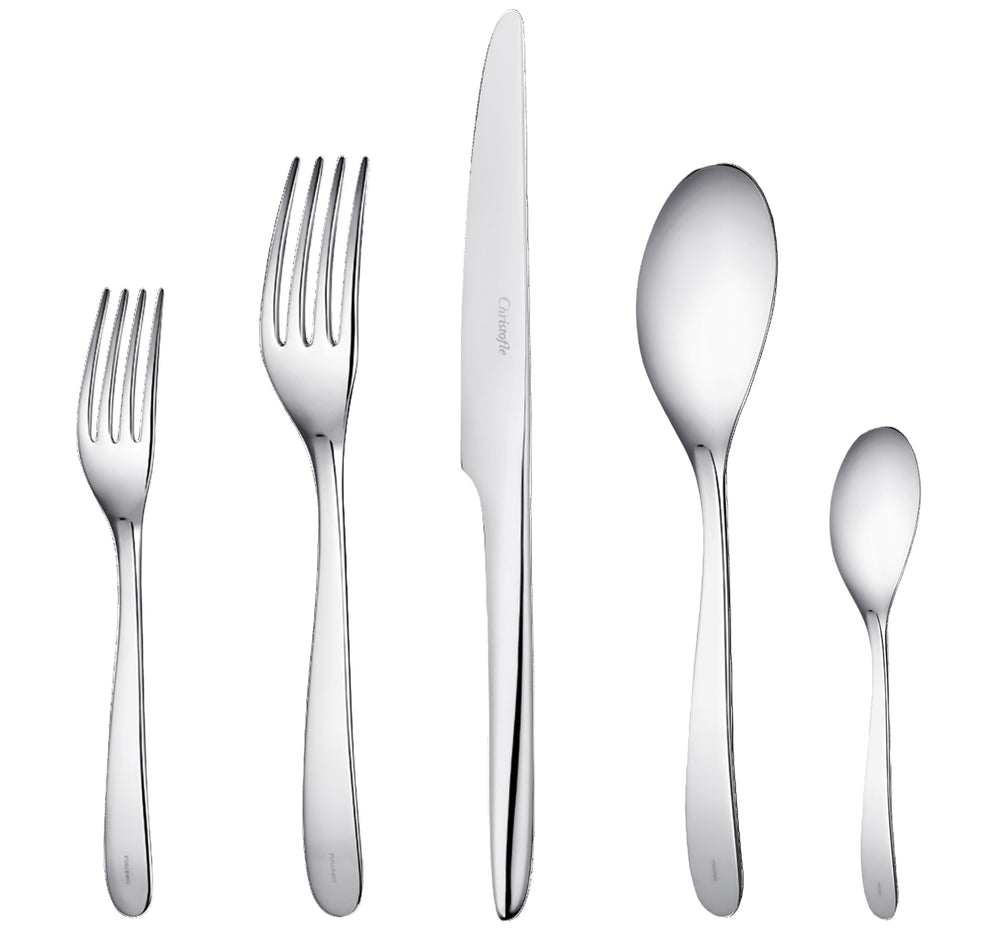 Top view of L’Ame de Christofle 5-piece stainless steel place setting: dessert fork, dinner fork, serrated knife, tablespoon, coffee spoon on white background