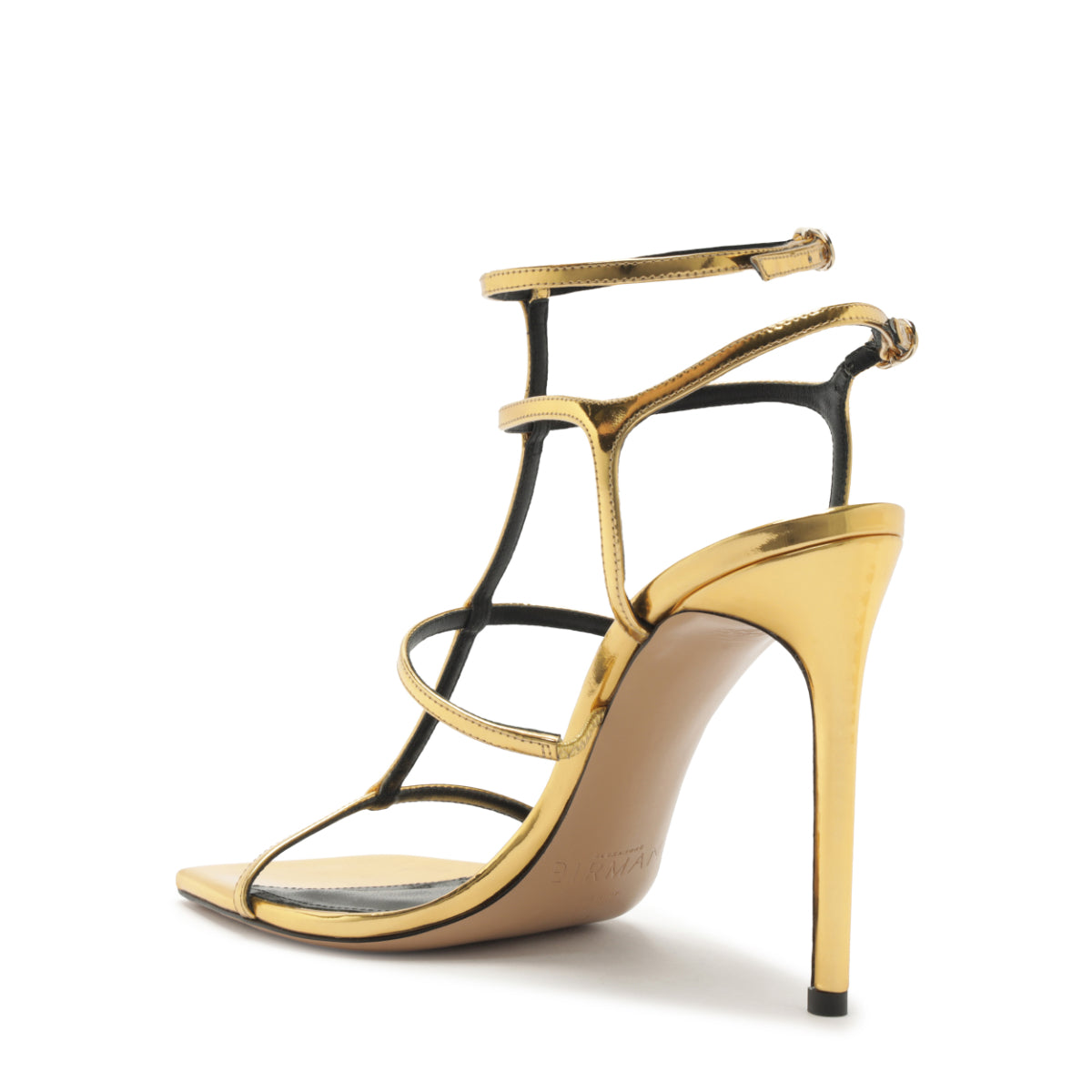 Three-quarter view of Amanda 100 sandal showcasing golden specchio leather, strappy design, and stiletto heel on white background