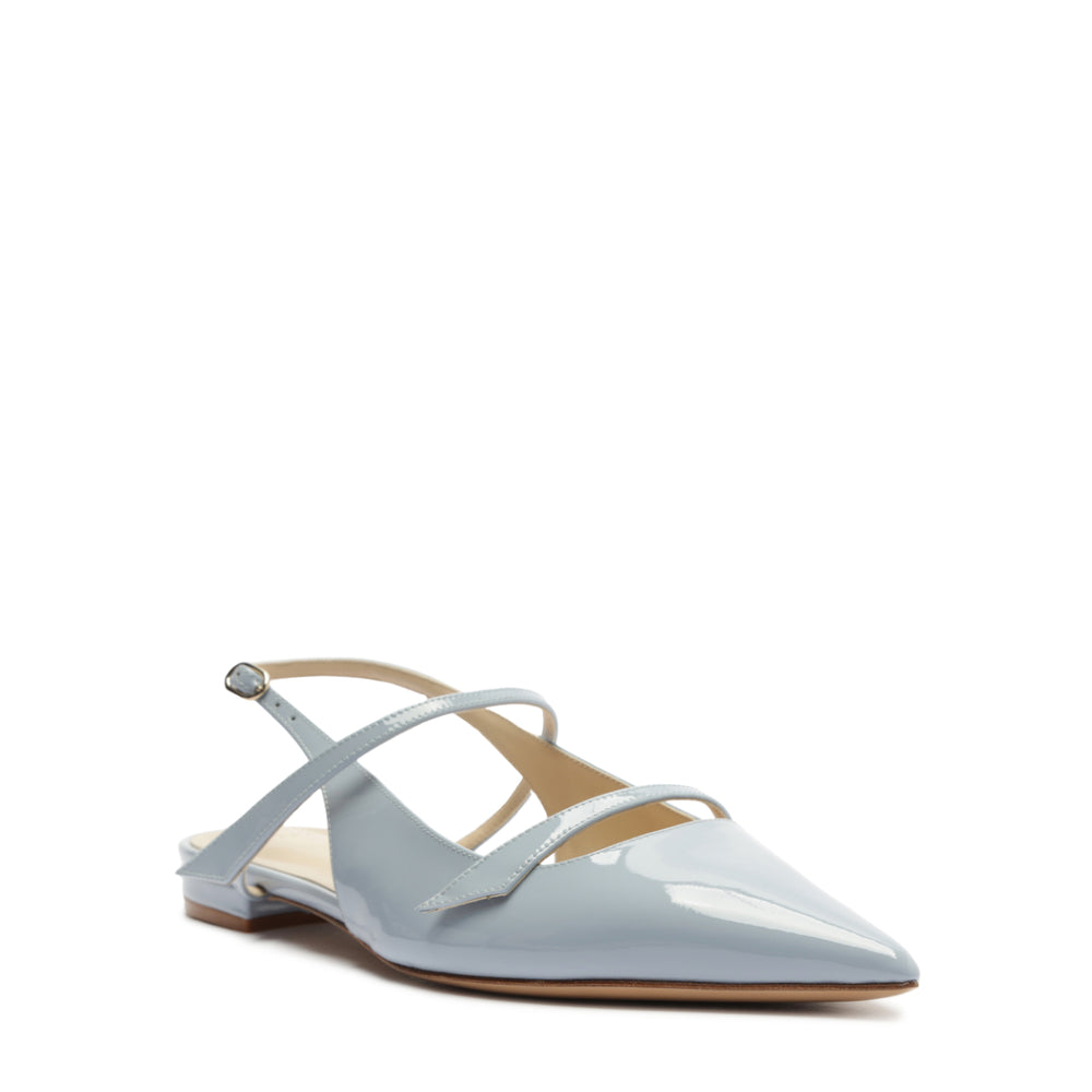Front three quarter view of Tita Flat in Azzuro showing pointed toe, crossed straps, slingback on white