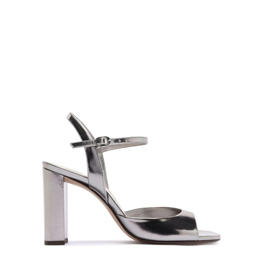 Side view of Amy 90 in Grafite sandal showcasing metallic leather upper, ankle strap, and block heel on a white background