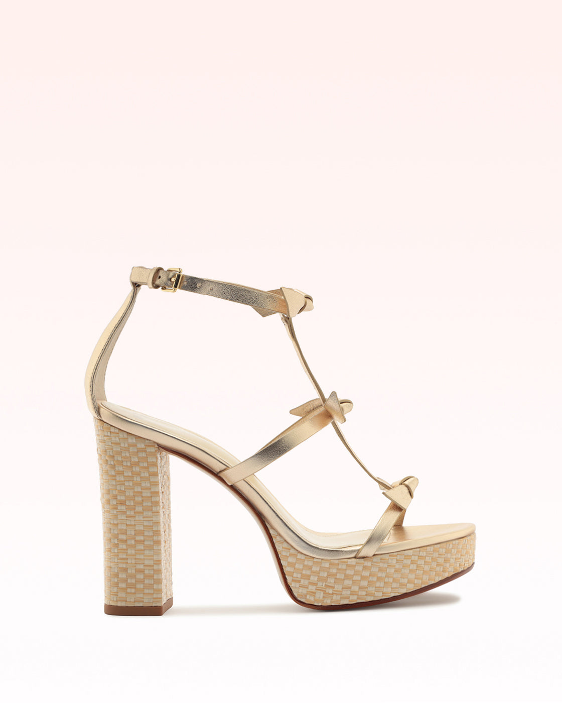 Side view of Slim Lolita Raffia 120 sandal showcasing gold metallic T-strap and raffia-wrapped block heel on pale pink