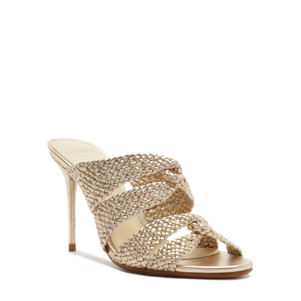 Three-quarter view of Sabrina 85 mule in golden showcasing braided leather straps, open back and slender stiletto heel on white background