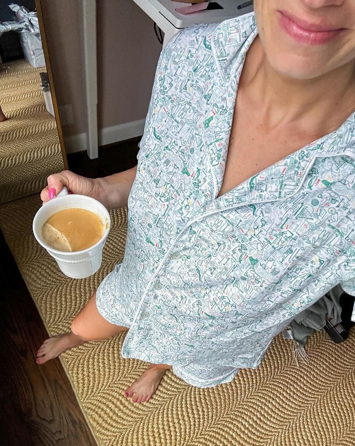 Close-up view of Golf Women’s Button Front Short Pajama Set showcasing golf print and collared top with a coffee cup indoors