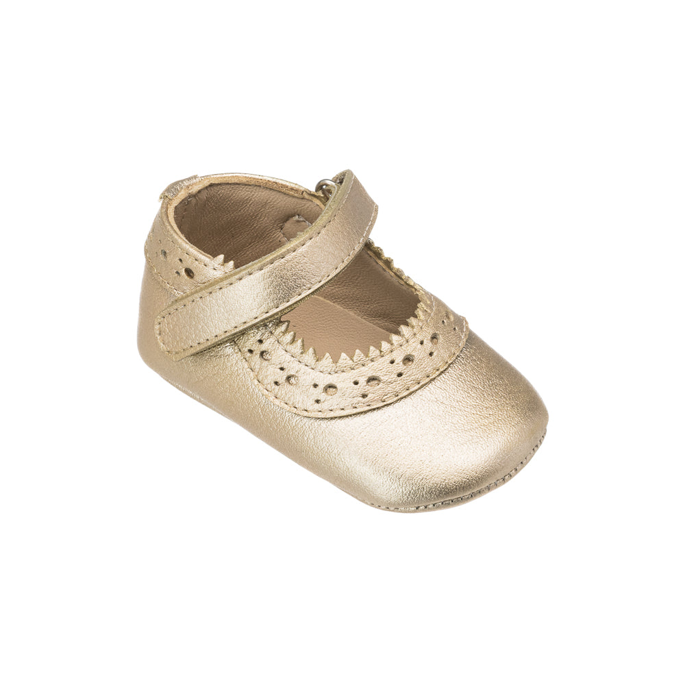 Angled view of Mellie Mary Jane baby shoe in gold showing scalloped trim, perforated detail and Mary Jane strap on white