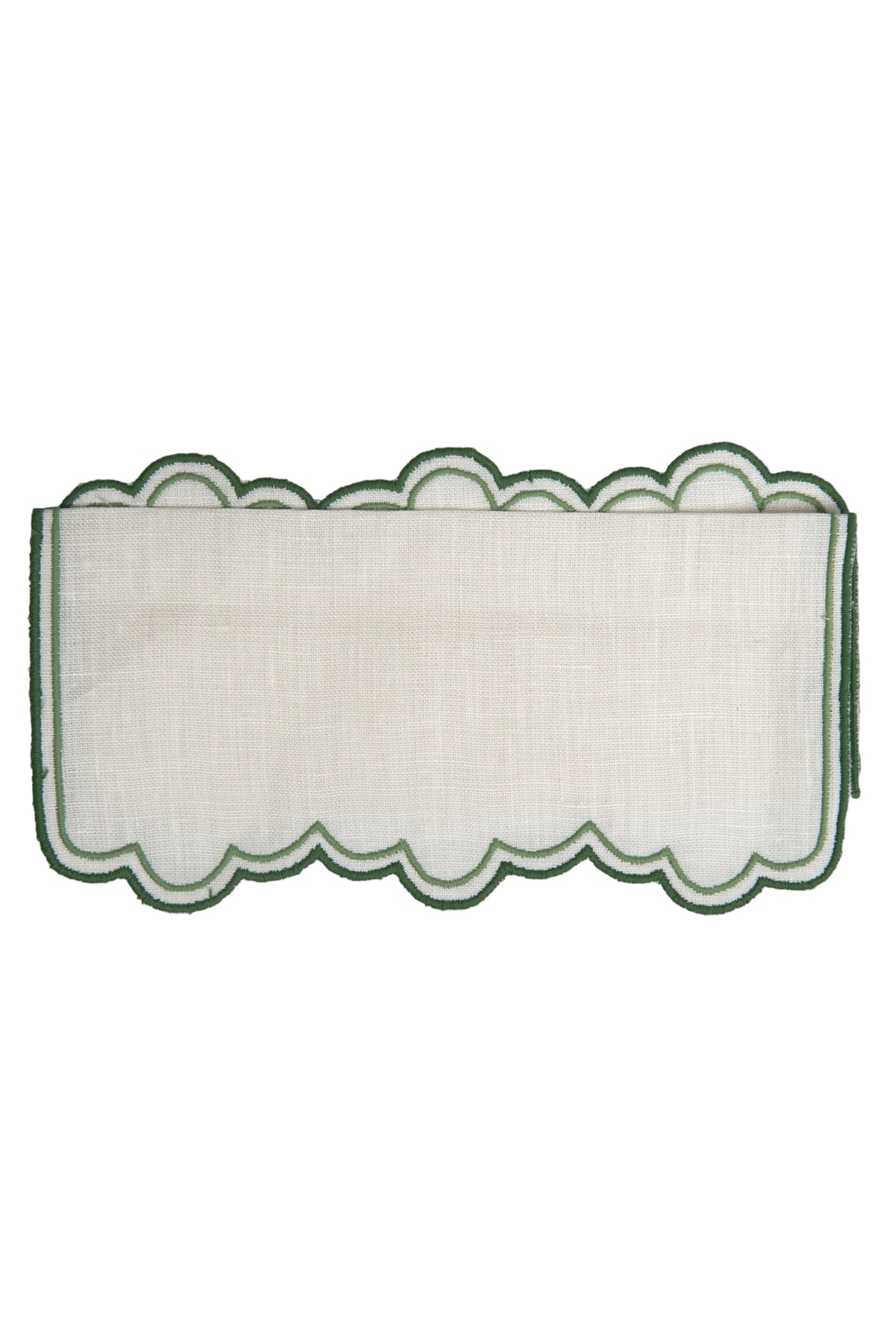 Top view of Escama cocktail napkin showing white linen and green double scalloped embroidered edge on white background