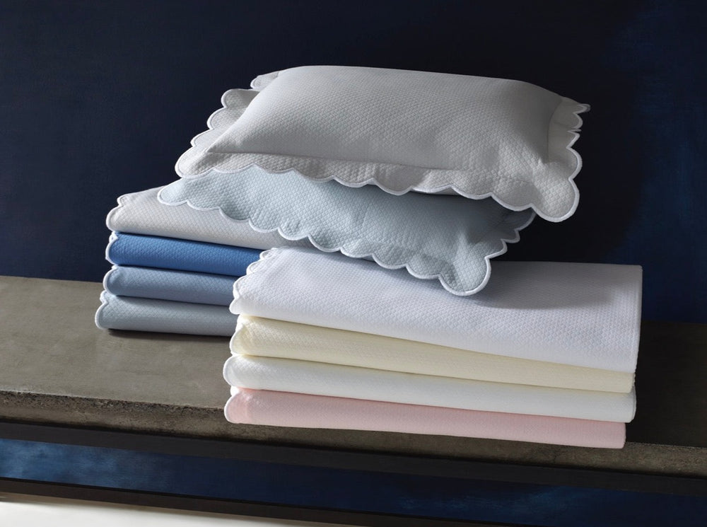 Stacked Diamond Pique bedding with scalloped edge shams and textured diamond pique in pastel colors