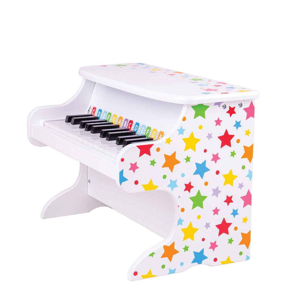 Three-quarter view of Table Top Piano showcasing colorful star print and color-coded replica keys on white background