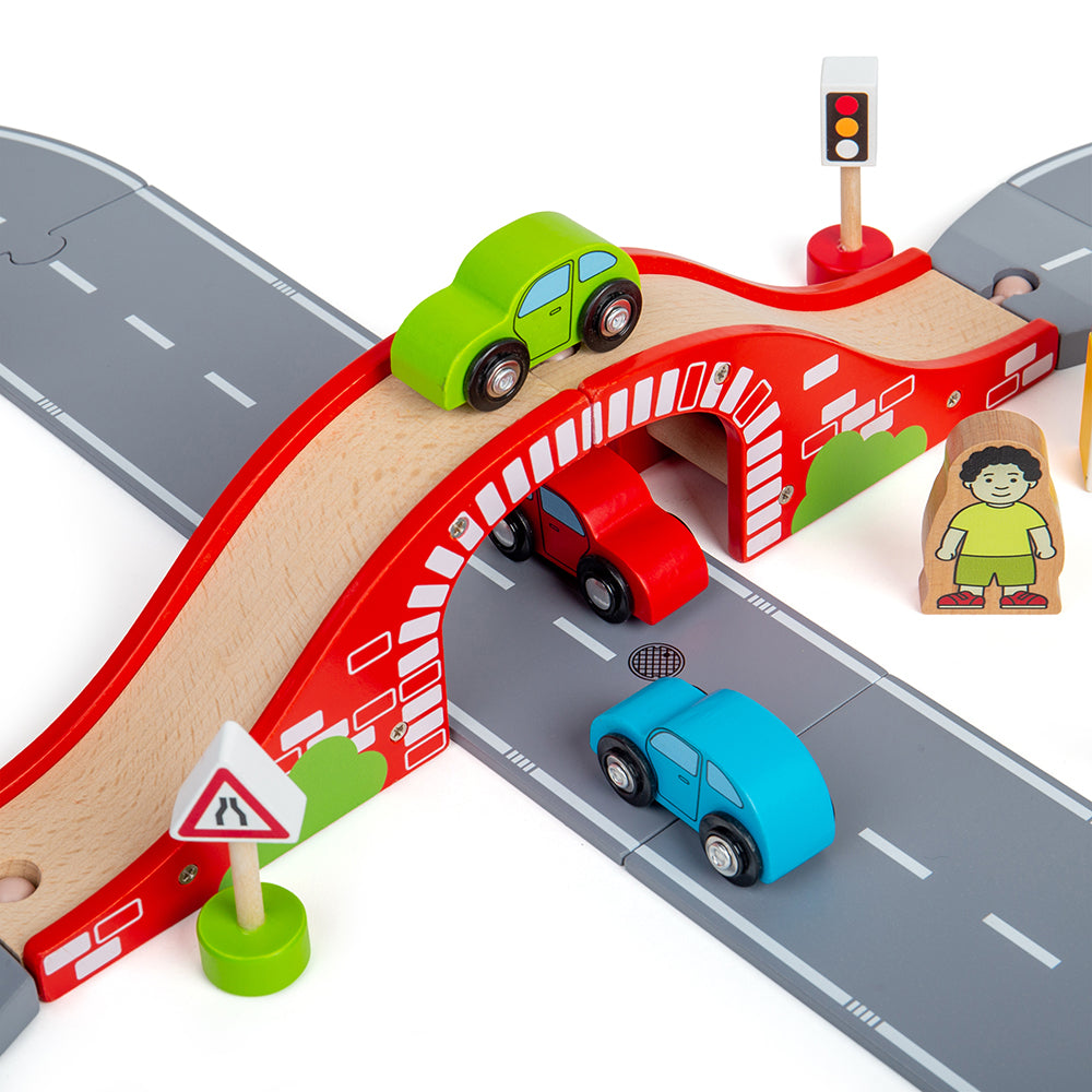 Close-up view of Figure of 8 Roadway showcasing red bridge, grey road tracks, three wooden cars and road accessories on white background