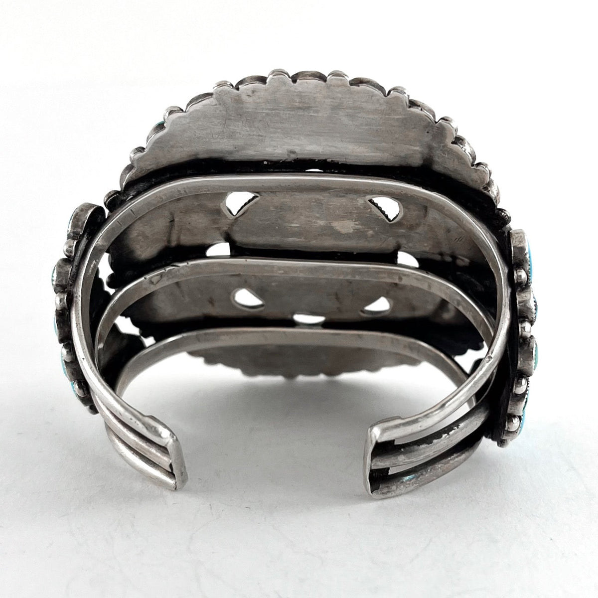 Rear view of Vintage Zuni Cluster Bracelet showcasing its open sterling silver cuff with a white background