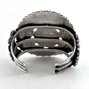 Rear view of Vintage Zuni Cluster Bracelet showcasing its open sterling silver cuff with a white background