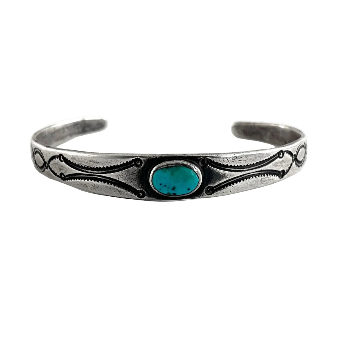 Front view of vintage single stone bracelet showing oval American turquoise, plain silver bezel, and engraved open cuff