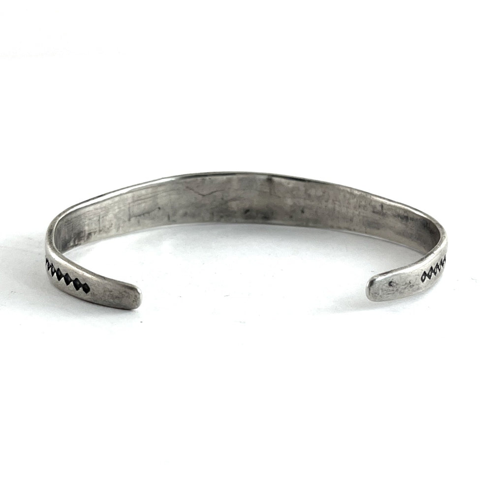 Open view of Vintage Single Stone Bracelet showcasing its sterling silver cuff and end details on a white background