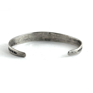 Open view of Vintage Single Stone Bracelet showcasing its sterling silver cuff and end details on a white background