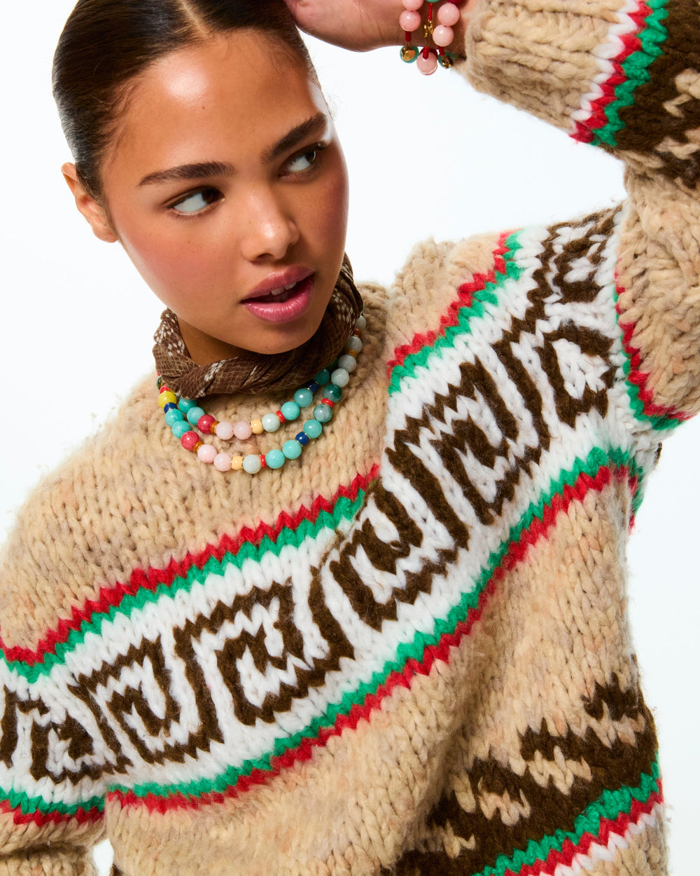 Close-up of Bright By Nature necklace layered on model showing multicolored beads and enamel rondelles on white background