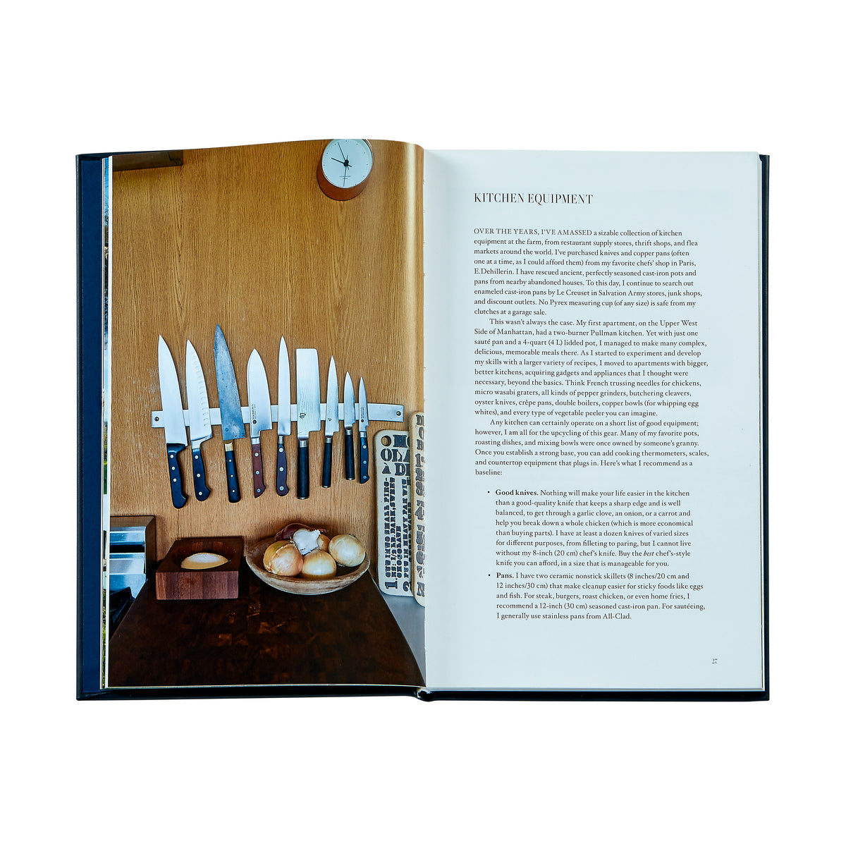Front-facing open view of A Man and His Kitchen bonded leather book showing interior spread with a magnetic knife strip photo and text on a white background