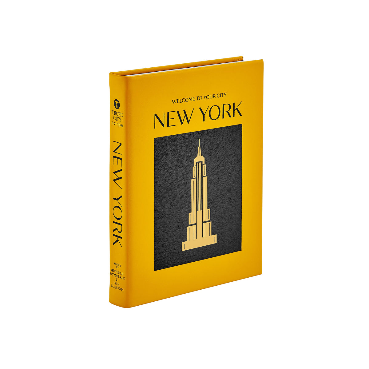 Three-quarter view of Trope New York hardcover book with yellow leather cover, black inset and gold embossed skyline on white