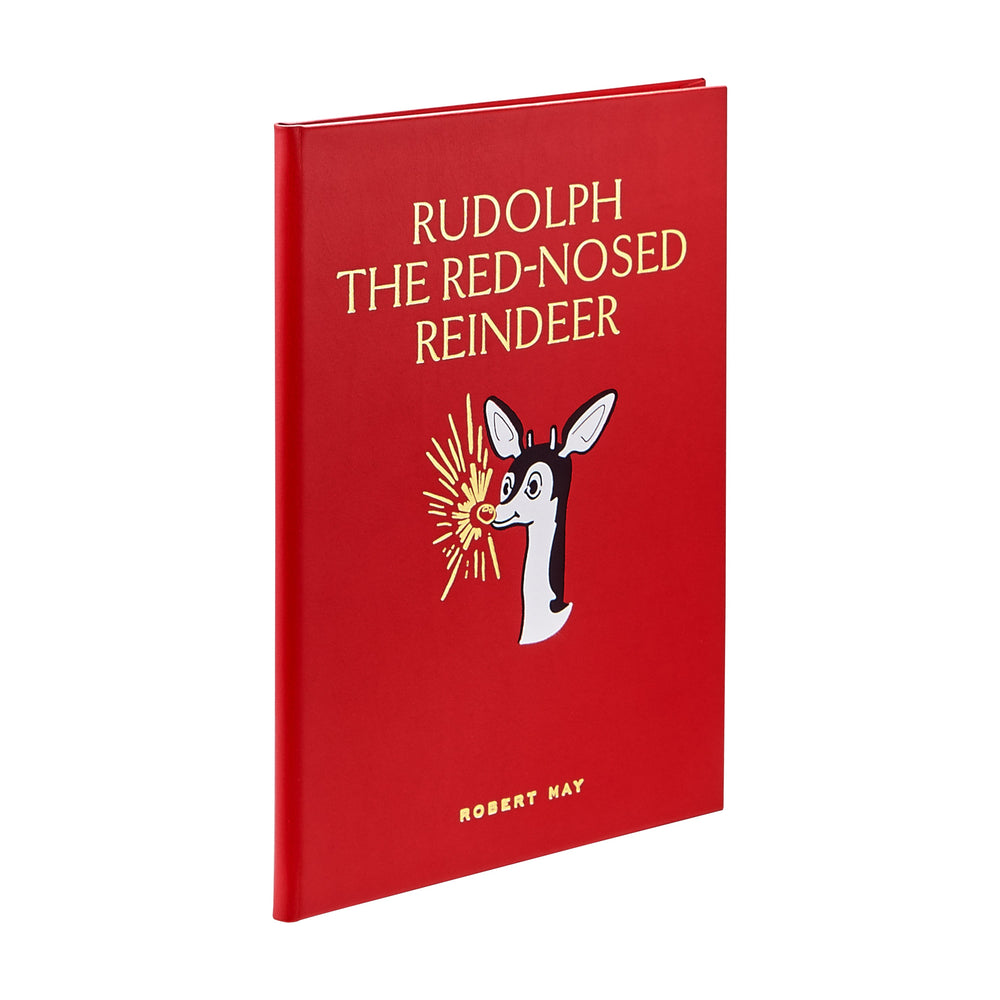 Three-quarter view of leather-bound Rudolph book with red cover, gold embossed title, and reindeer illustration on white