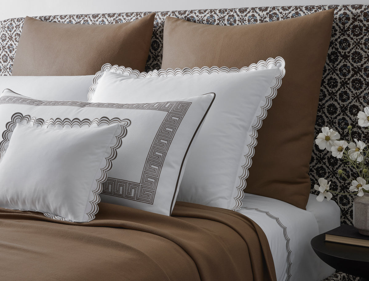 Angled view of Dream Modal Throw in mocha showcasing soft lightweight drape on a styled bed with white scalloped shams