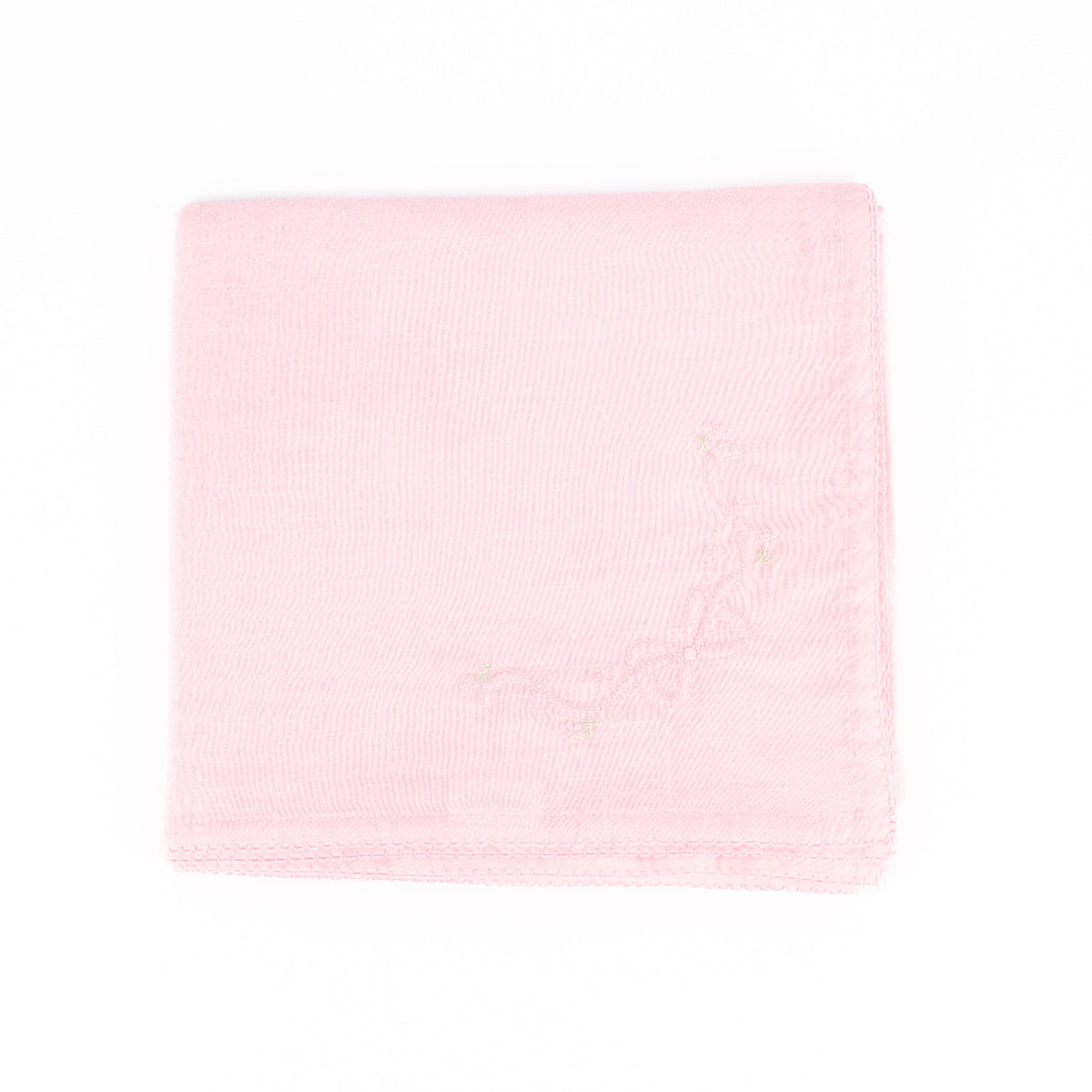 Top-down view of folded pink receiving blanket showing scalloped hem and small embroidered floral vine on a white background