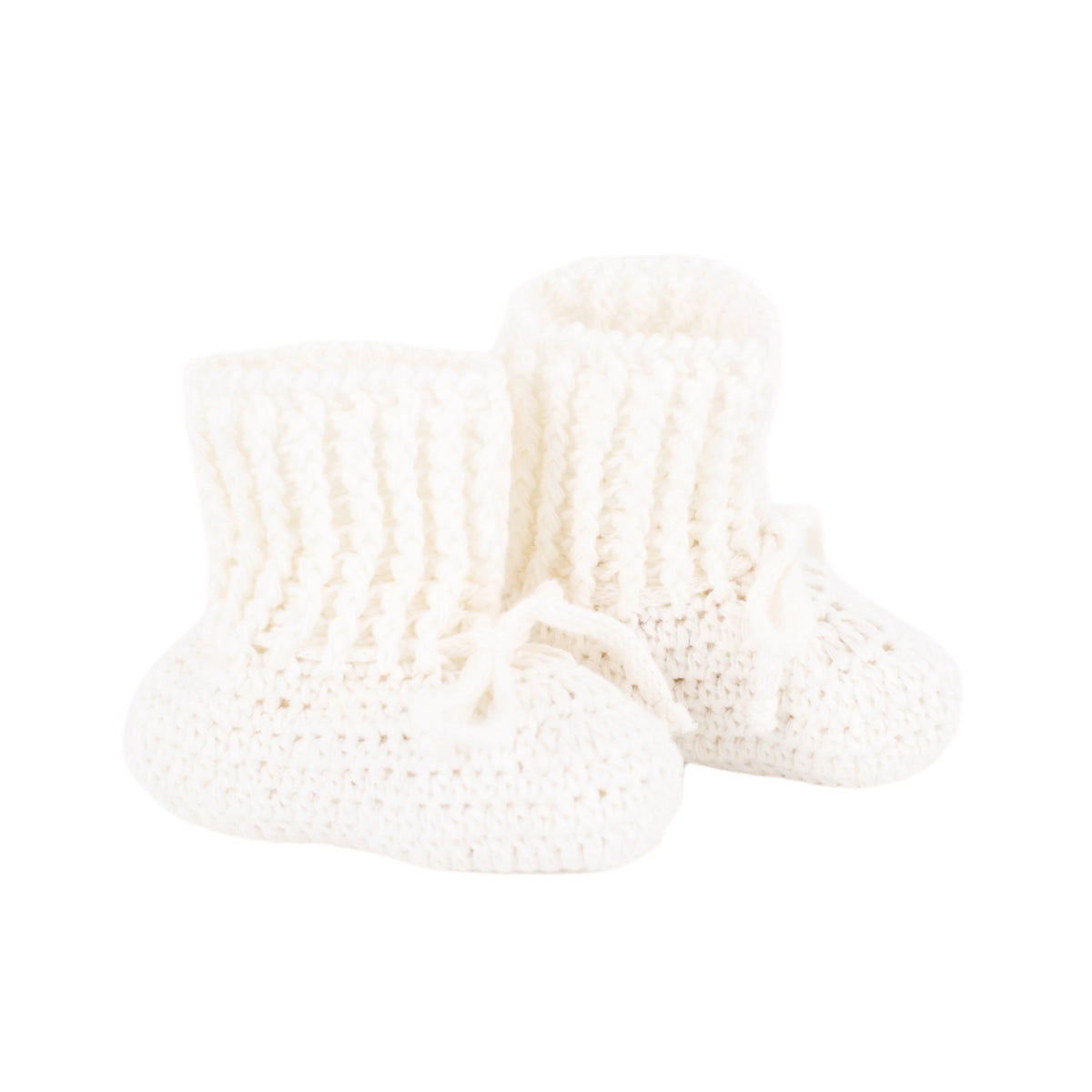 Front three-quarter view of knit baby booties in ivory showcasing ribbed ankle cuffs and tie fastenings on white background