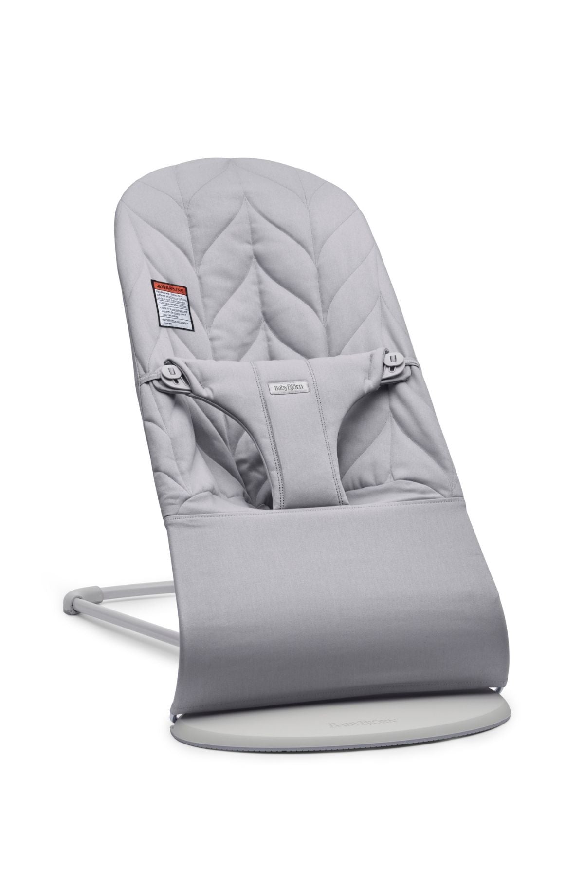 Front three-quarter view of Bouncer Bliss in Petal Quilt Light Gray showcasing its quilted seat and safety harness against a white background