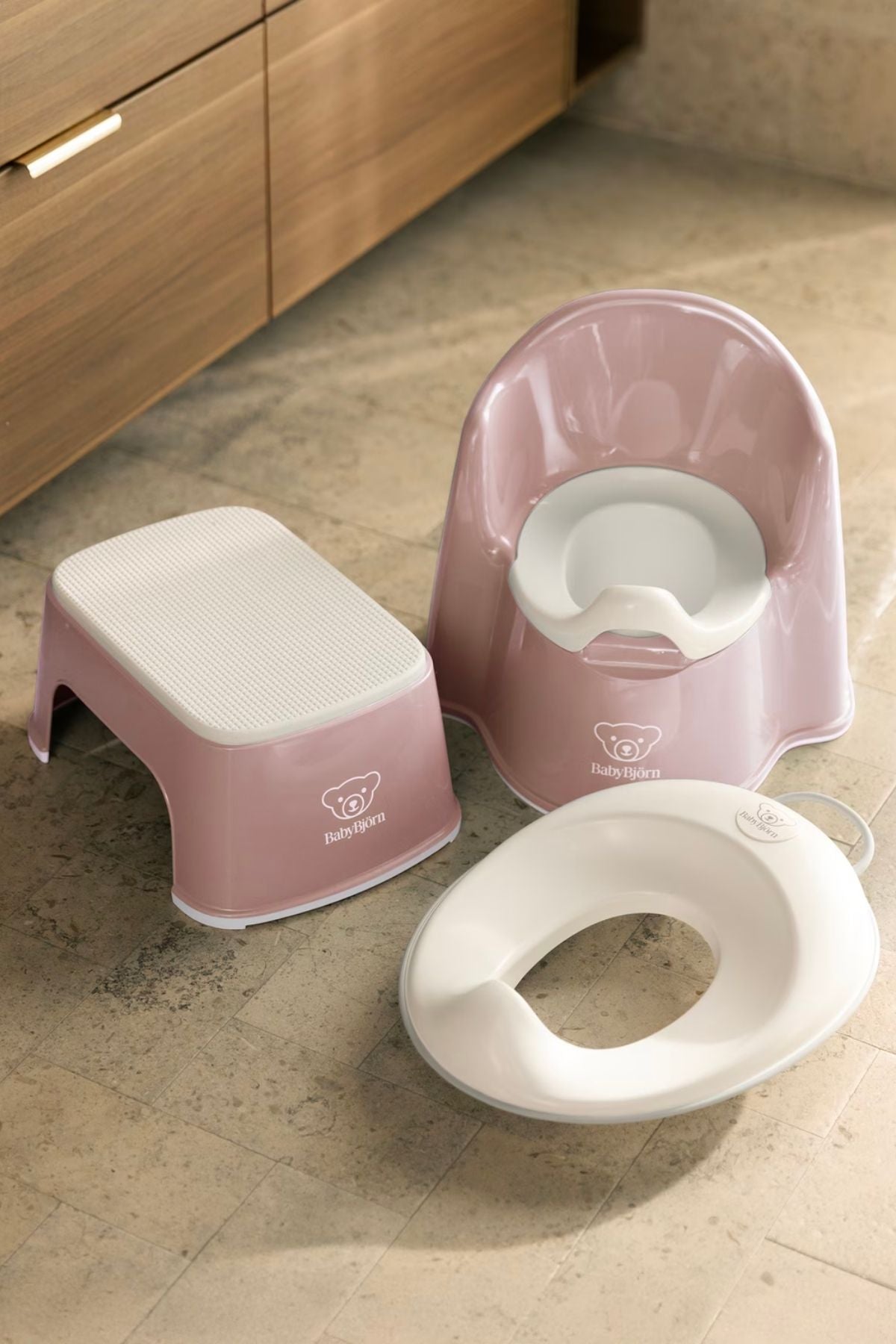Close view of Potty Training Bundle in Powder Pink and White with potty chair, step stool, and toilet training seat