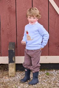 Little English traditional children's clothing. Light blue crew neck intarsia sweater with seated lab motif layered over lab printed turtleneck and paired with chocolate brown corduroy banded pants.