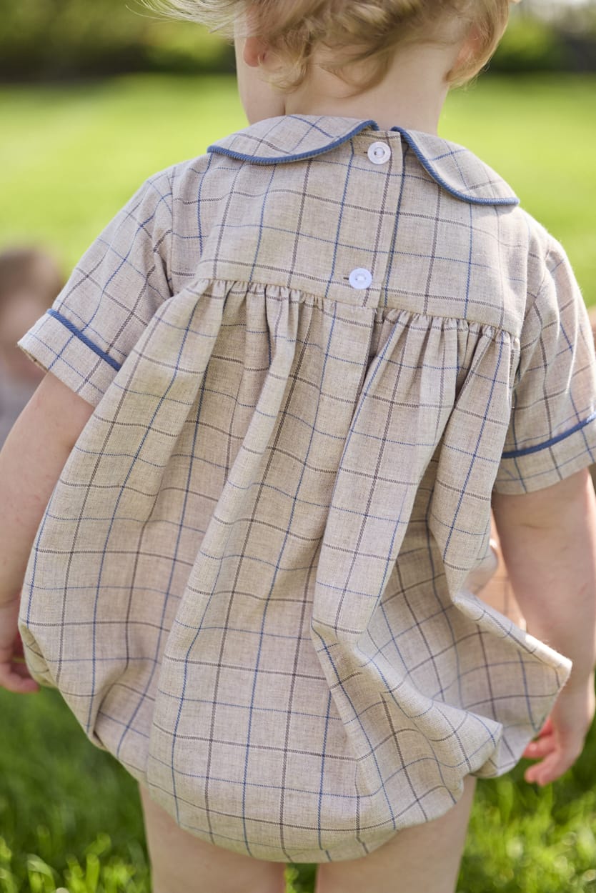 Little English classic children's clothing.  Smocked peter pan bubble in tan and blue Durham windowpane with blue piping for baby boys
