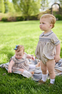 Little English classic children's clothing.  Smocked peter pan bubble in tan and blue Durham windowpane with blue piping for baby boys