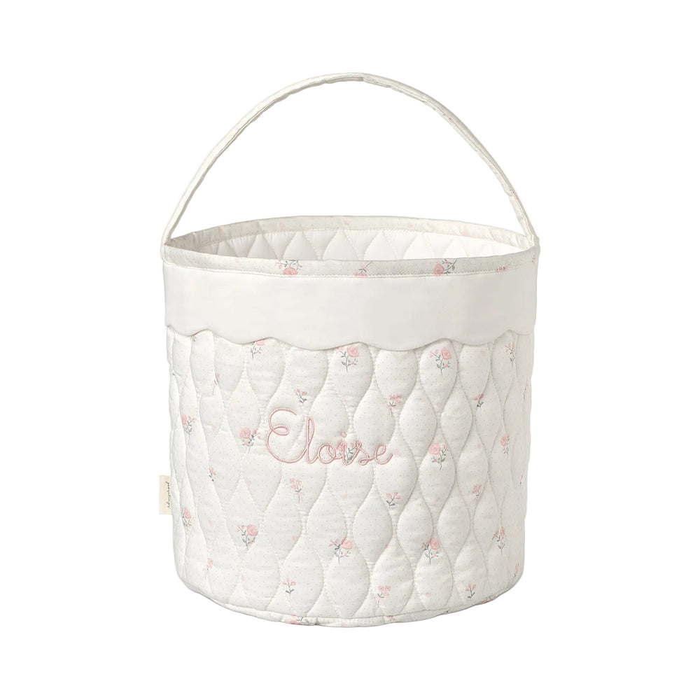 Quilted storage basket with soft pink floral pattern and 'Eloise' embroidery on a white background