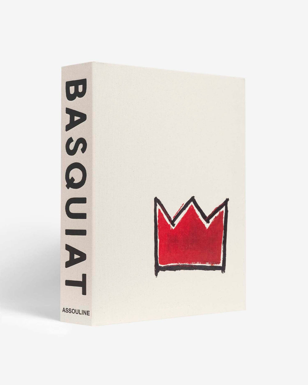 Basquiat: The World of Jean-Michel by Assouline: angled three-quarter view of the cream woven canvas book; BASQUIAT in tall bold black type on the spine with ASSOULINE at the base; the front cover features Basquiat's iconic red crown motif — a hand-drawn red crown with black outline — centered on the cream textured ground