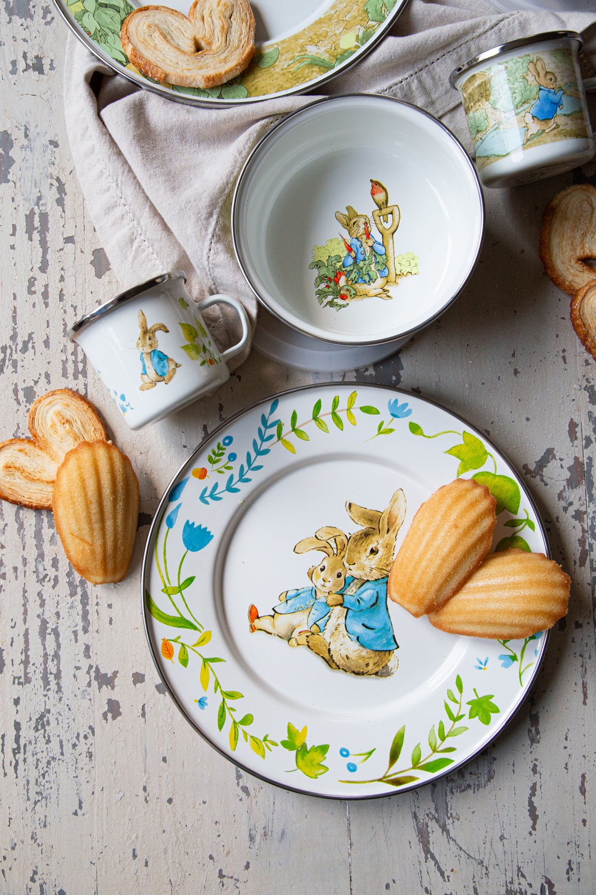 Overhead view of Child Set in Spring Leaves showcasing Beatrix Potter illustrations on a weathered table