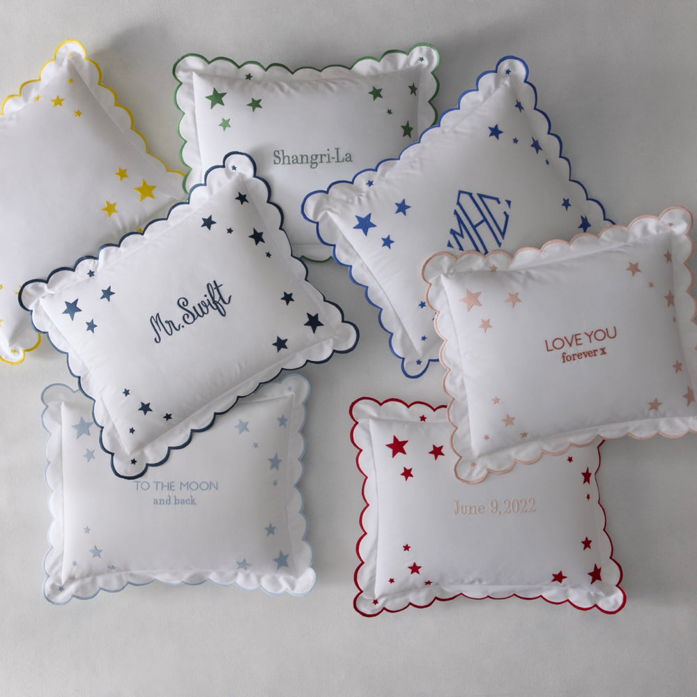 Overhead view of Stars Mini Pillows showcasing scalloped edges and embroidered star motif on a light gray background