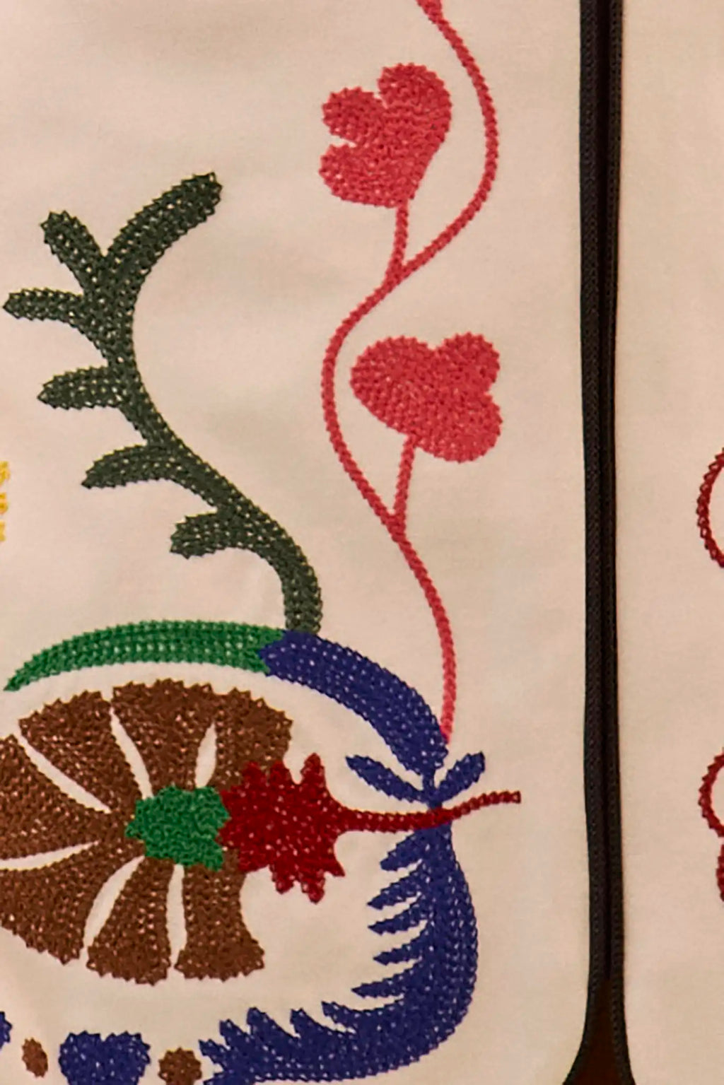 The Dottie Mini Skirt is a white A-line skirt with fitted waist and colorful hem throughout.