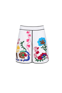 The Dottie Mini Skirt is a white A-line skirt with fitted waist and colorful hem throughout.