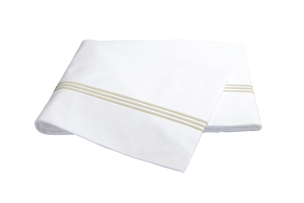 Folded Bel Tempo flat sheet showing almond triple-stripe hem on white background