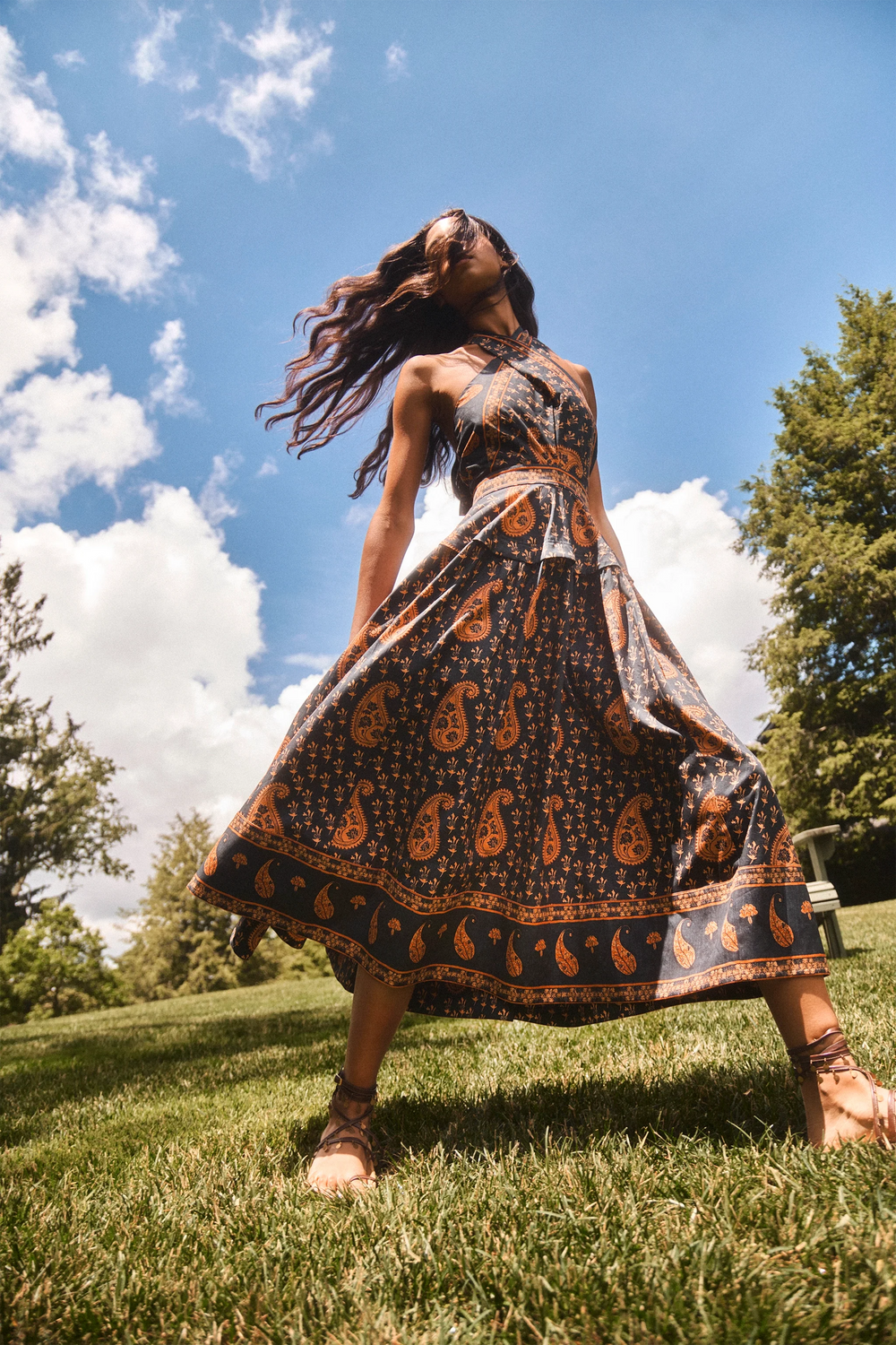 The Bellamy Dress in Glen Paisley flowing in the wind outside. 