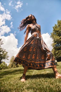 The Bellamy Dress in Glen Paisley flowing in the wind outside. 